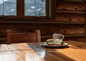 Served slice bread with hot espresso in a cup on  wooden lodge