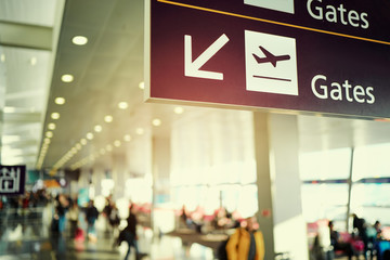 Sign in terminal with an arrow showing direction. Interior of the airport.