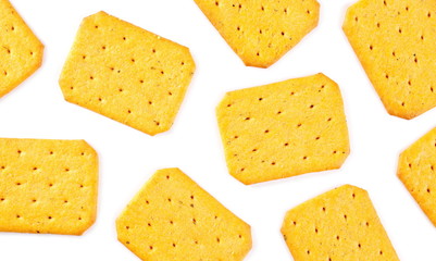 Salty crackers, snacks pile isolated on white background, top view