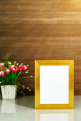 Picture mock up with golden frame on table