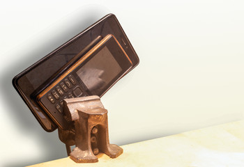 Mobile phone and smartphone on a metal cliche