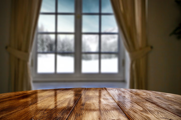 Desk of free space and blurred winter window background. 