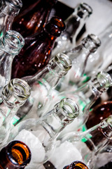 Glass bottles in container, close up
