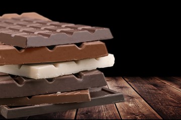 Stack delicious chocolates on wooden desk