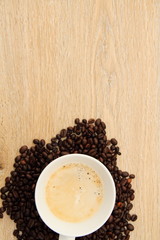a cup with coffee and coffee beans