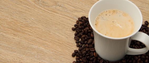 a cup with coffee and coffee beans
