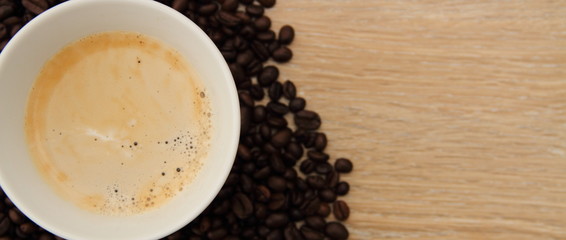 a cup with coffee and coffee beans