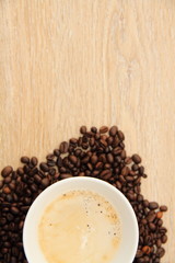 a cup with coffee and coffee beans