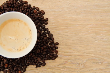 a cup with coffee and coffee beans