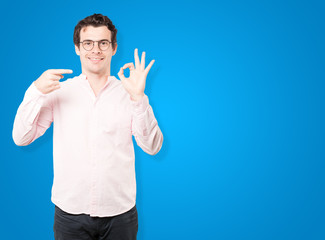 Happy young man doing an all right gesture