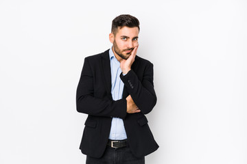 Young caucasian business man against a white background isolated who is bored, fatigued and need a relax day.