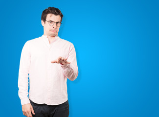 Concerned young man with a gesture of disgust