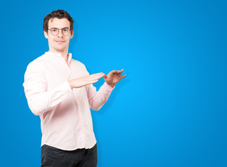 Friendly young man doing a gesture of keep calm