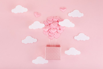 Valentine heart air ballon for Valentine's day. Hot air baloon greeting card with white cloud on pink background.