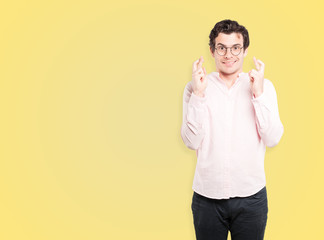 Happy young man doing a crossed fingers gesture