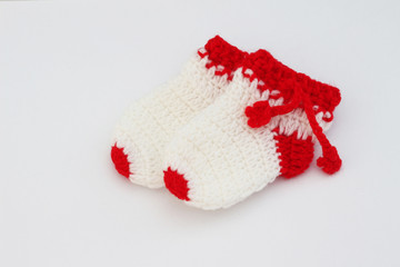 Handmade sweet baby booties isolated on white background