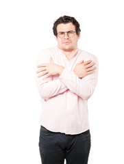 Concerned young man making a gesture of being cold