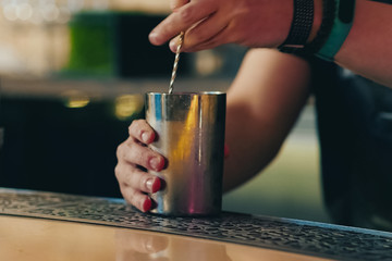 Fototapeta na wymiar Bartender pouring cocktail at bar counter