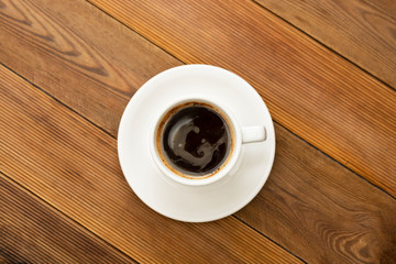Coffee cup isolated on wooden table. Top view, flat lay coffee drink with copy space.