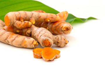  raw organic  turmeric roots with green leaves