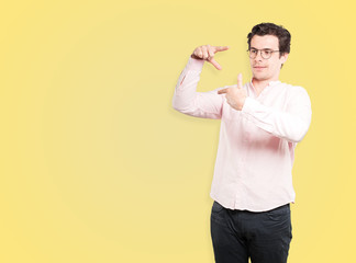 Friendly young man making a gesture of taking a photo with the hands