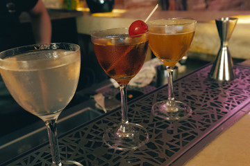 Bartender pouring cocktail at bar counter