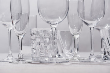 Empty glasses on white surface isolated on grey