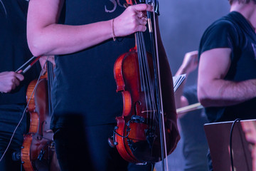 Classical musician violinist with a musical instrument violin playing at the concert