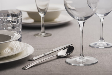 Selective focus of serving dishware on grey tablecloth