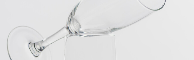 Panoramic shot of two champagne glasses isolated on grey