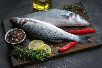 Fresh seabass and ingredients for cooking.