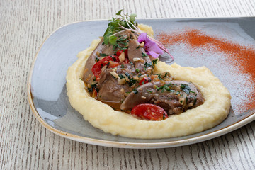 Lamb tongues with mashed potatoes, stewed in a sauce with thyme and herbs