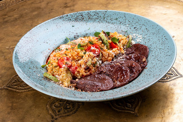 Veal tongues, stewed with bulgur. Classic retro Russian dish