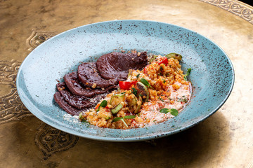 Veal tongues, stewed with bulgur. Classic retro Russian dish