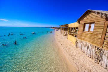 Orange Bay Beach with crystal clear azure water and white beach - paradise coastline of Giftun island, Mahmya, Hurghada, Red Sea, Egypt.