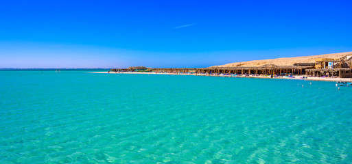 Obraz na płótnie Canvas Orange Bay Beach with crystal clear azure water and white beach - paradise coastline of Giftun island, Mahmya, Hurghada, Red Sea, Egypt.