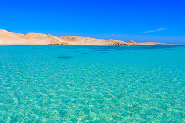 Fototapeta na wymiar Orange Bay Beach with crystal clear azure water and white beach - paradise coastline of Giftun island, Mahmya, Hurghada, Red Sea, Egypt.