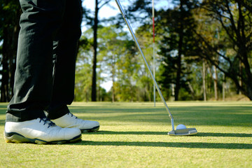 Obraz premium Golfer playing golf in beautiful golf course in the evening golf course with sunshine