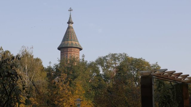  Bell tower of Metropolitan Cathedral in Timisoara over the trees 4K footage