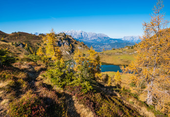 Fototapeta na wymiar Autumn alpine Grosser Paarsee or Paarseen lake, Land Salzburg, Austria. Alps Hochkonig rocky mountain group view in far.