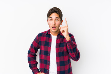 Young caucasian man posing in a pink background isolated having an idea, inspiration concept.