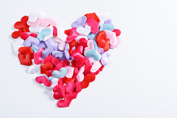 small multicolored hearts on white background