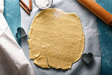 top view of cookie dough in the shape of heart on blue background
