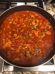 Home made pasta sauce simmering on the stove. - 314279389