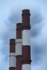 Large factory chimneys with smoke against a gray sky. Global warming image