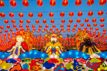 Asian Lantern Festival-Chinese lucky God and traditional chinese lantern on display in a Chinese temple at sunset for the chiniese new year festival .