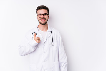 Young caucasian doctor man isolated smiling and raising thumb up