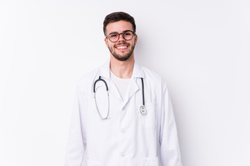 Fototapeta premium Young caucasian doctor man isolated happy, smiling and cheerful.