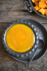 Creamy pumpkin soup topped with pumpkin seeds close-up	