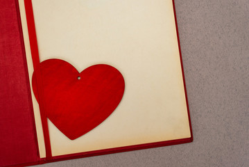 Valentines day red hearts on greeting card over old paper background.  Vintage retro romantic style.